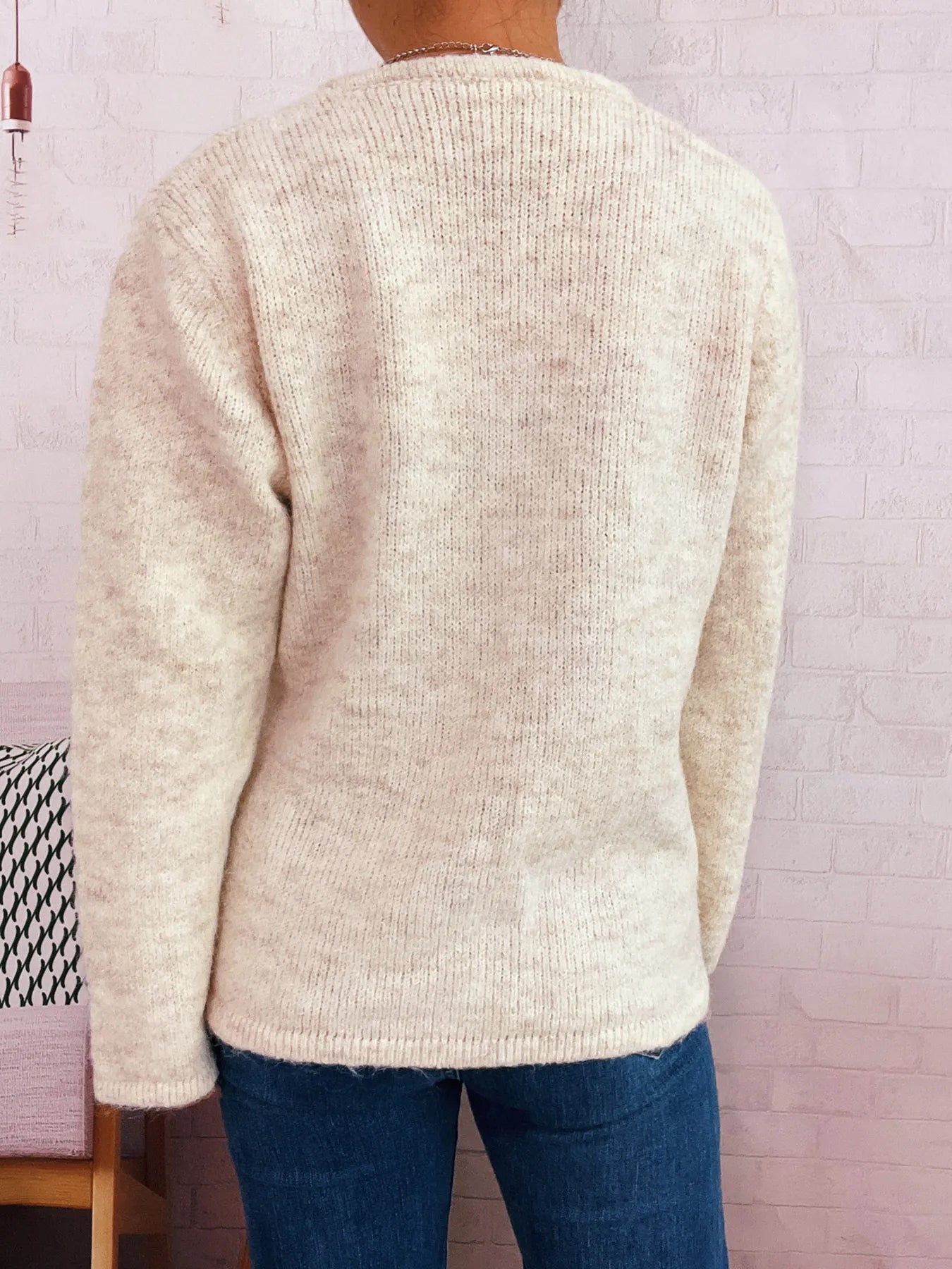 Apricot button-front side-tie sweater with long sleeves, knit texture, back view