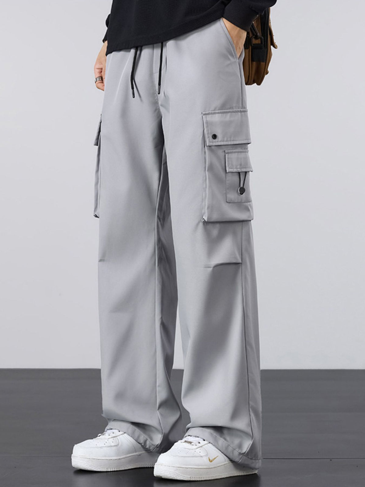 Light gray cargo pants with drawstring waist, loose fit, and side utility pocket