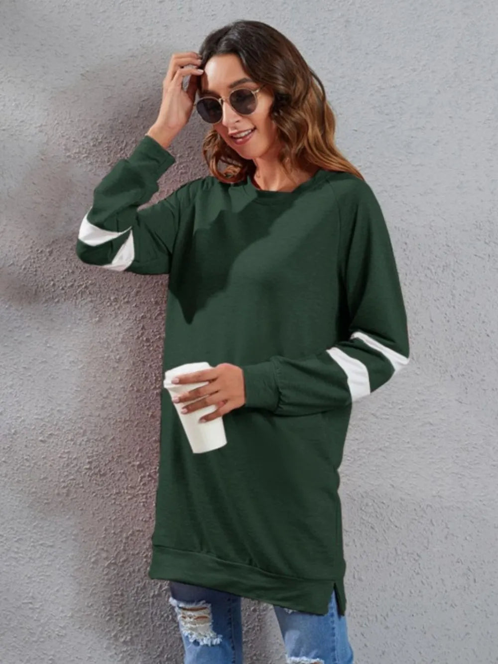 Dark green long-sleeve T-shirt with round neck, white striped sleeve cuffs, and pocket detail