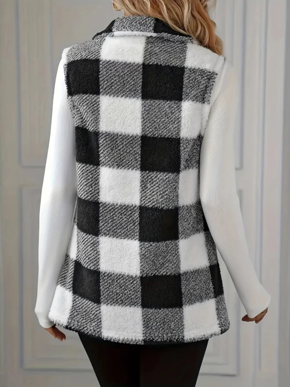Back view: sleeveless black-and-white plaid sherpa vest coat with button front