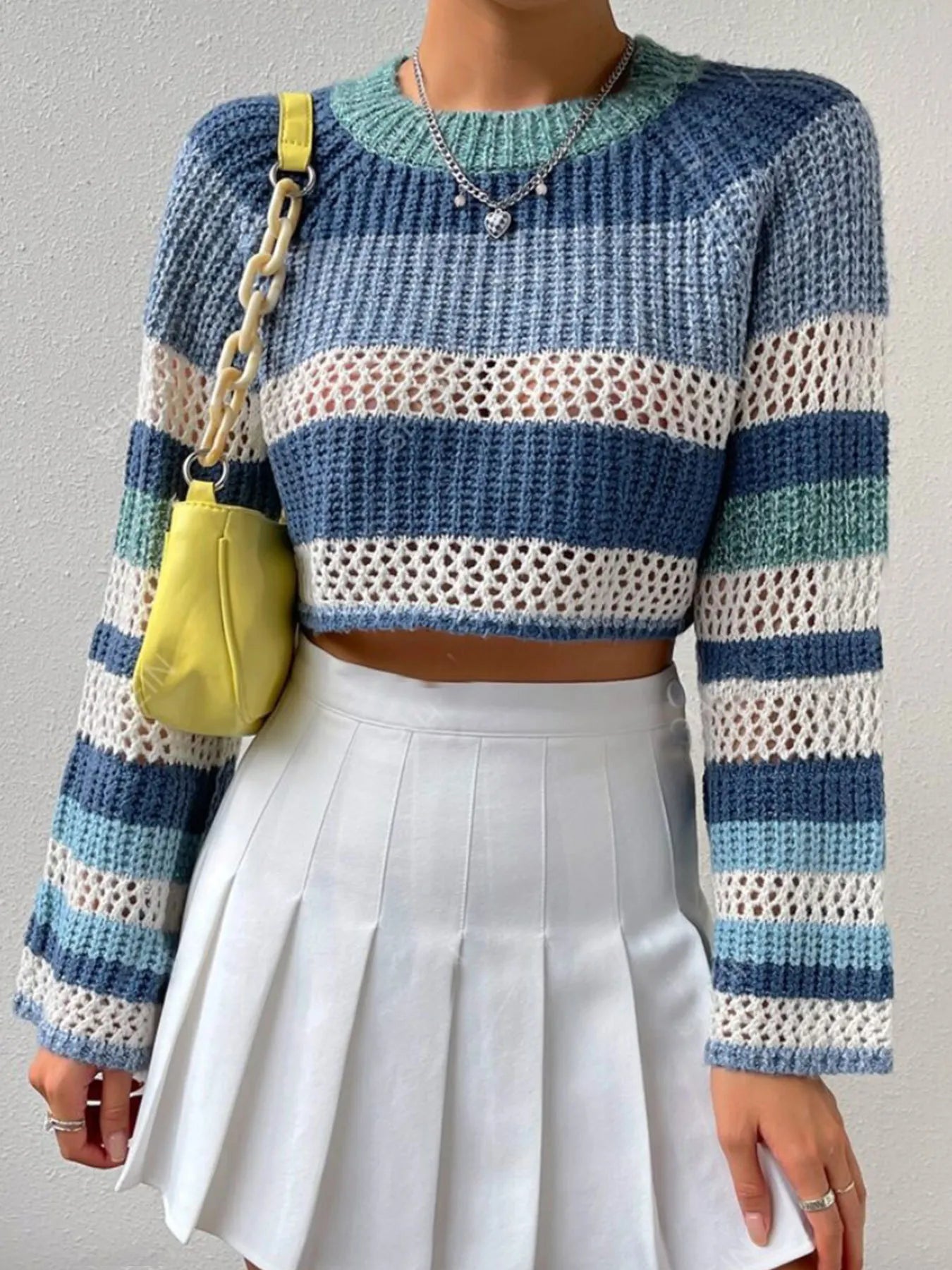 Striped color block crop sweater with open-knit texture, ribbed crew neckline, and sleeves