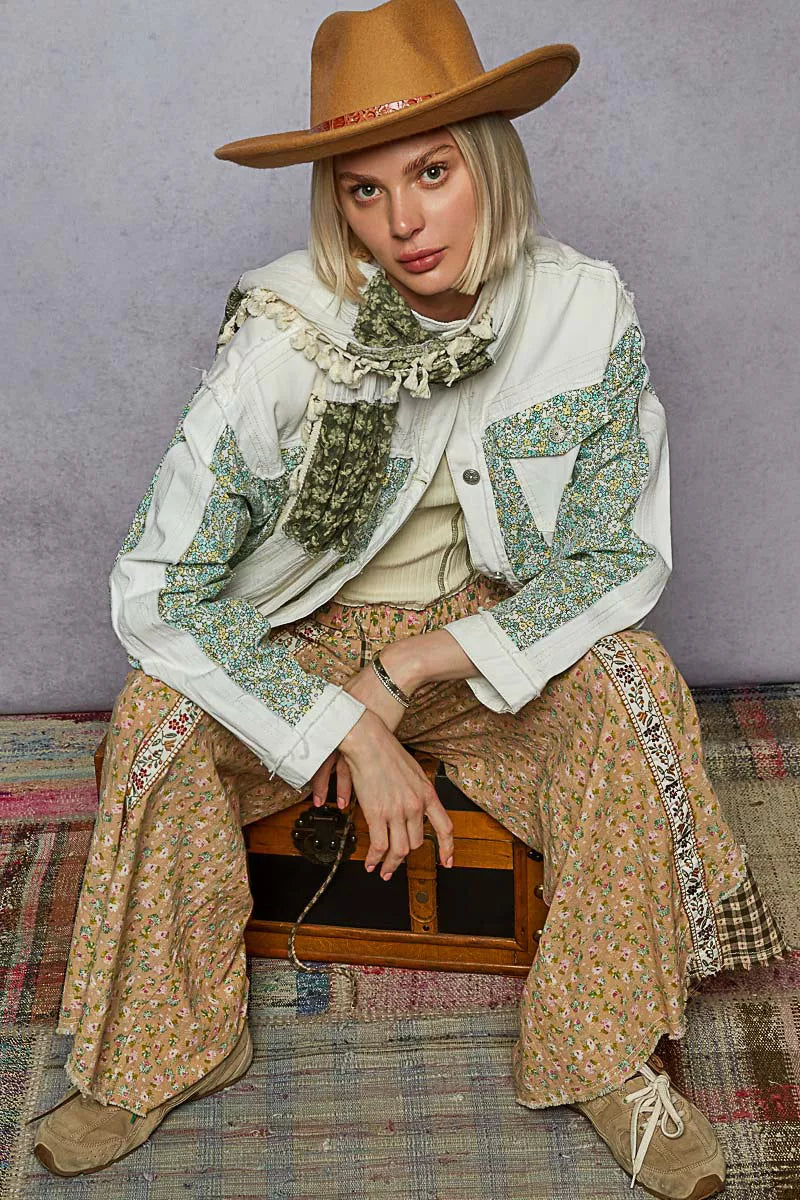 Off-white patchwork denim jacket with green floral patchwork, button front, chest pockets