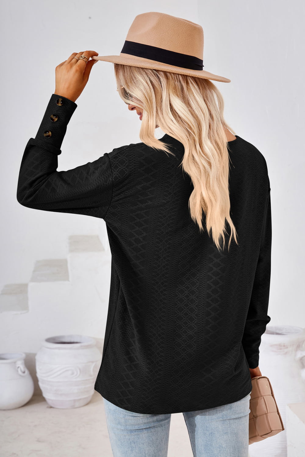 Dark V-neck long-sleeve blouse with textured diamond pattern