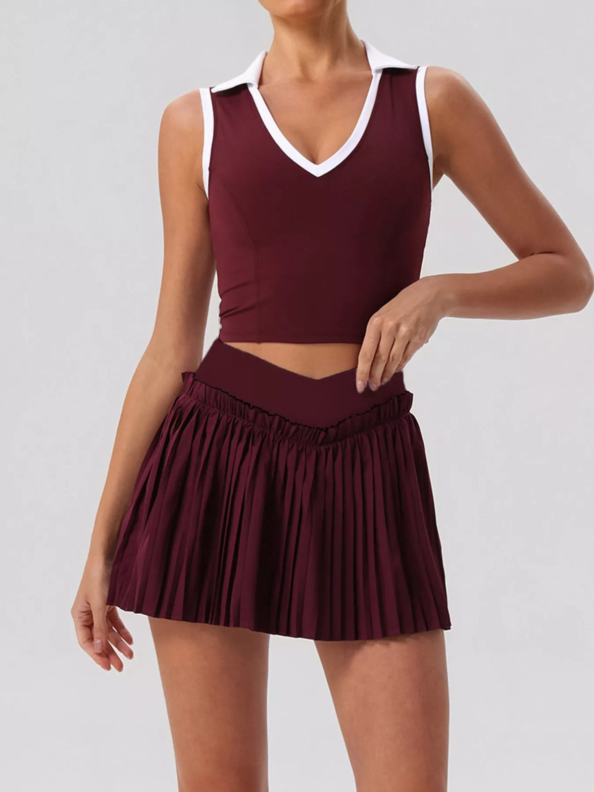Burgundy sleeveless V-neck crop top with elastic waist pleated mini skirt set
