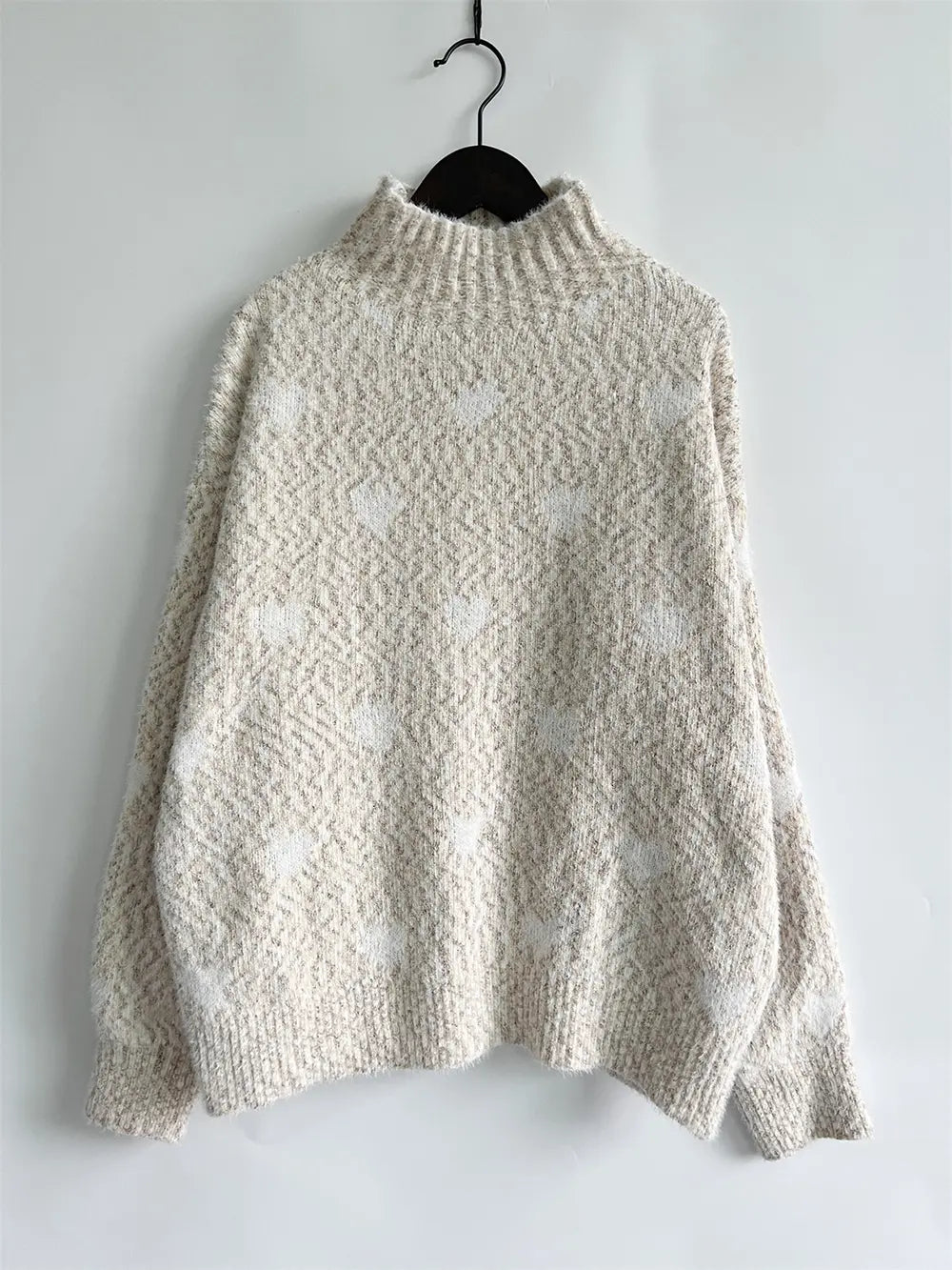 Cream heathered knit turtleneck sweater with drop shoulders and ribbed cuffs
