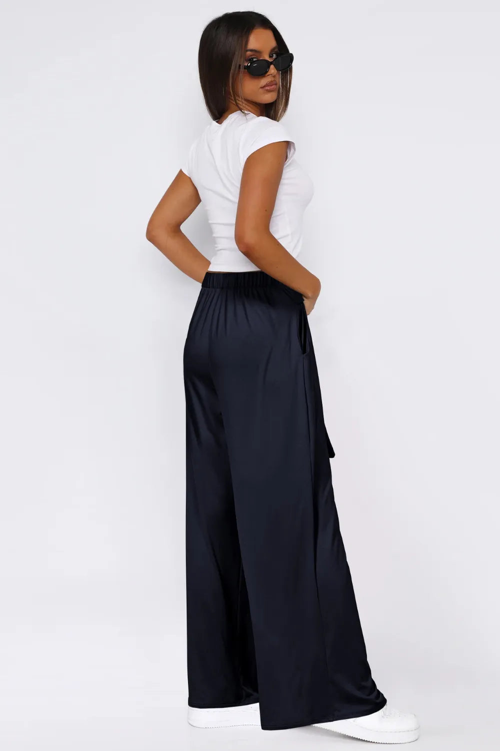 Dark navy wide-leg pants with tied waist and side pockets, wide leg opening.