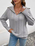 Gray cable knit half-zip sweater with ribbed collar and textured cable front