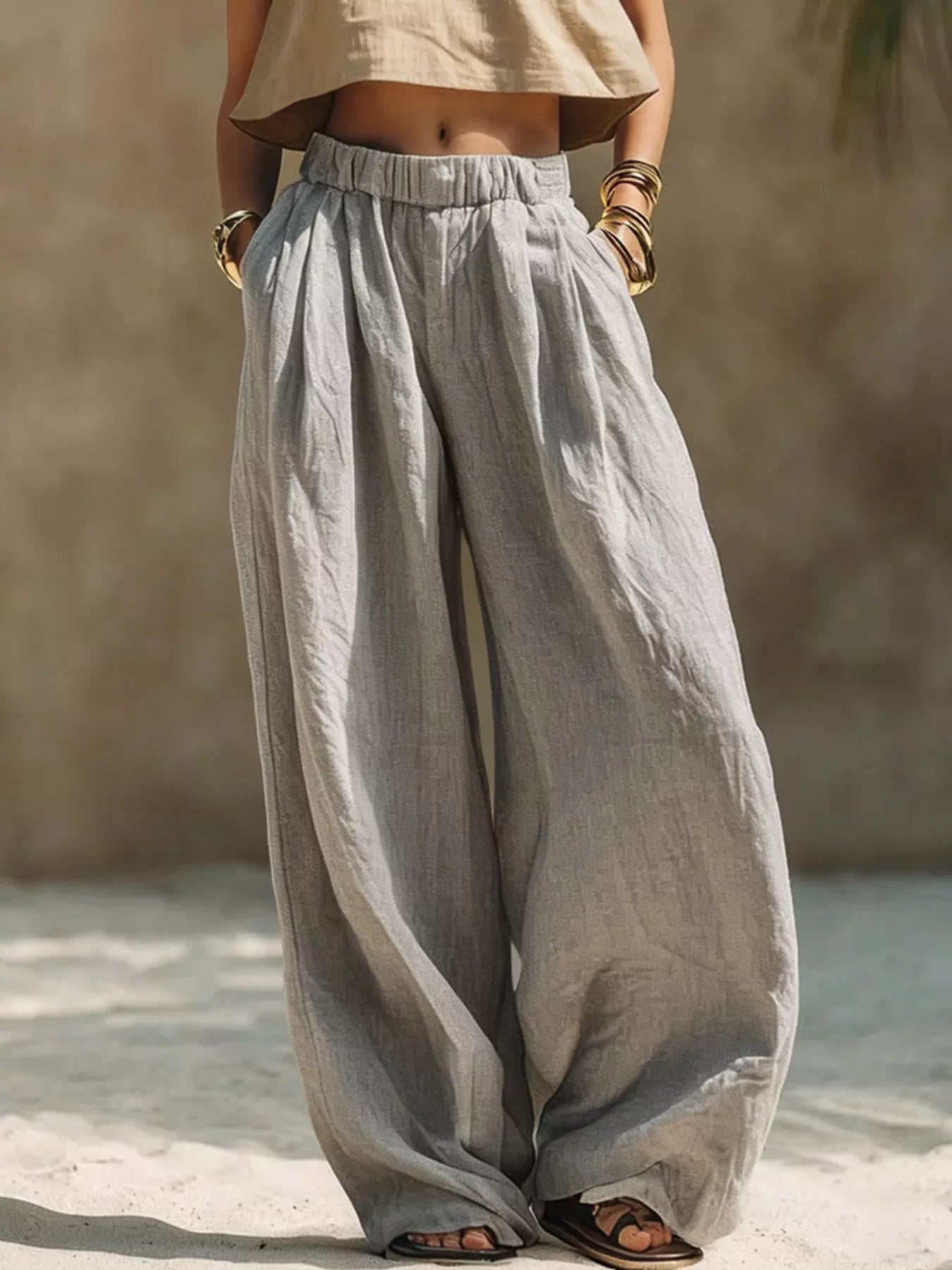 Gray wide-leg pants with elastic waist and soft pleats, relaxed full-length fit