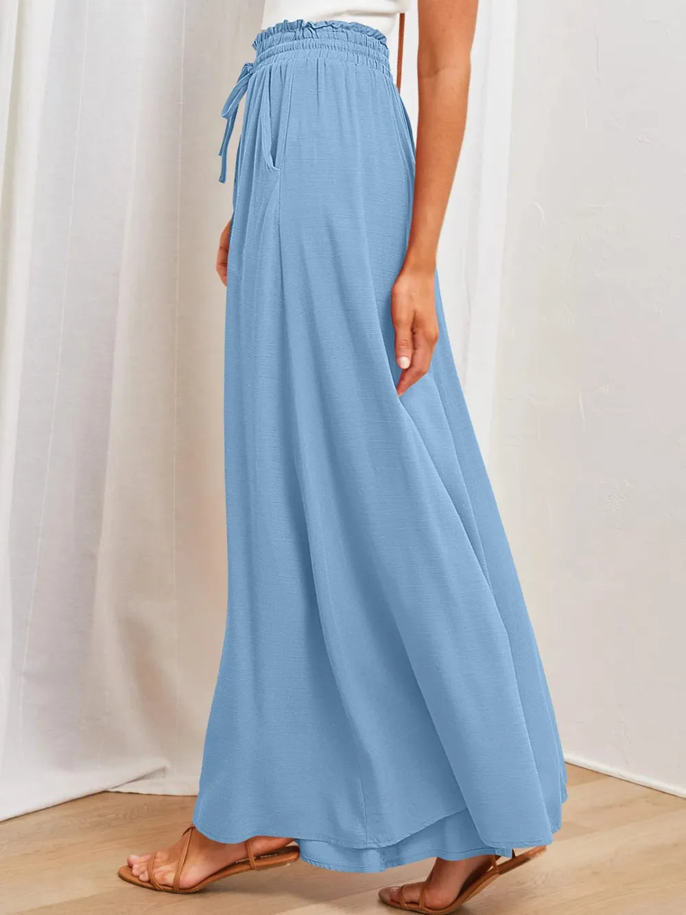 Light blue wide-leg pants with gathered elastic waist and relaxed flowing wide legs
