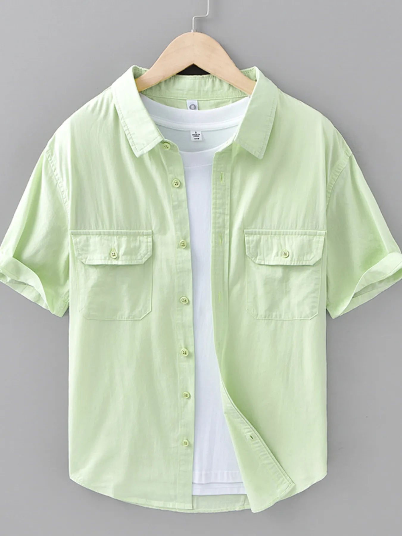 Light green short-sleeve button-up shirt with chest flap pockets and front buttons
