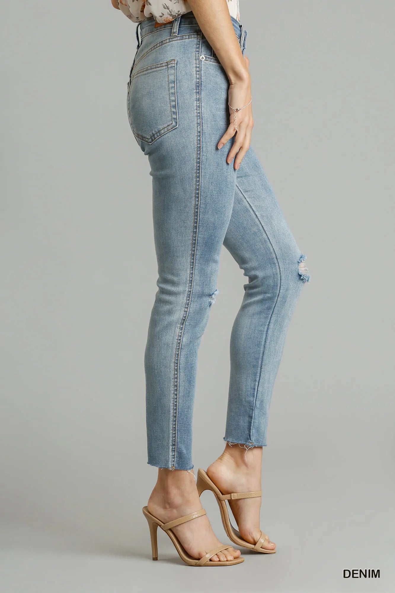 Light wash stretch skinny jeans, 5-pocket denim with side distress and frayed hem