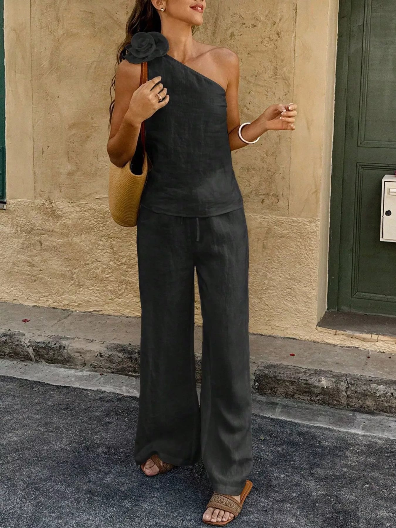 Black one-shoulder embellished top with wide-leg pants, full-length view