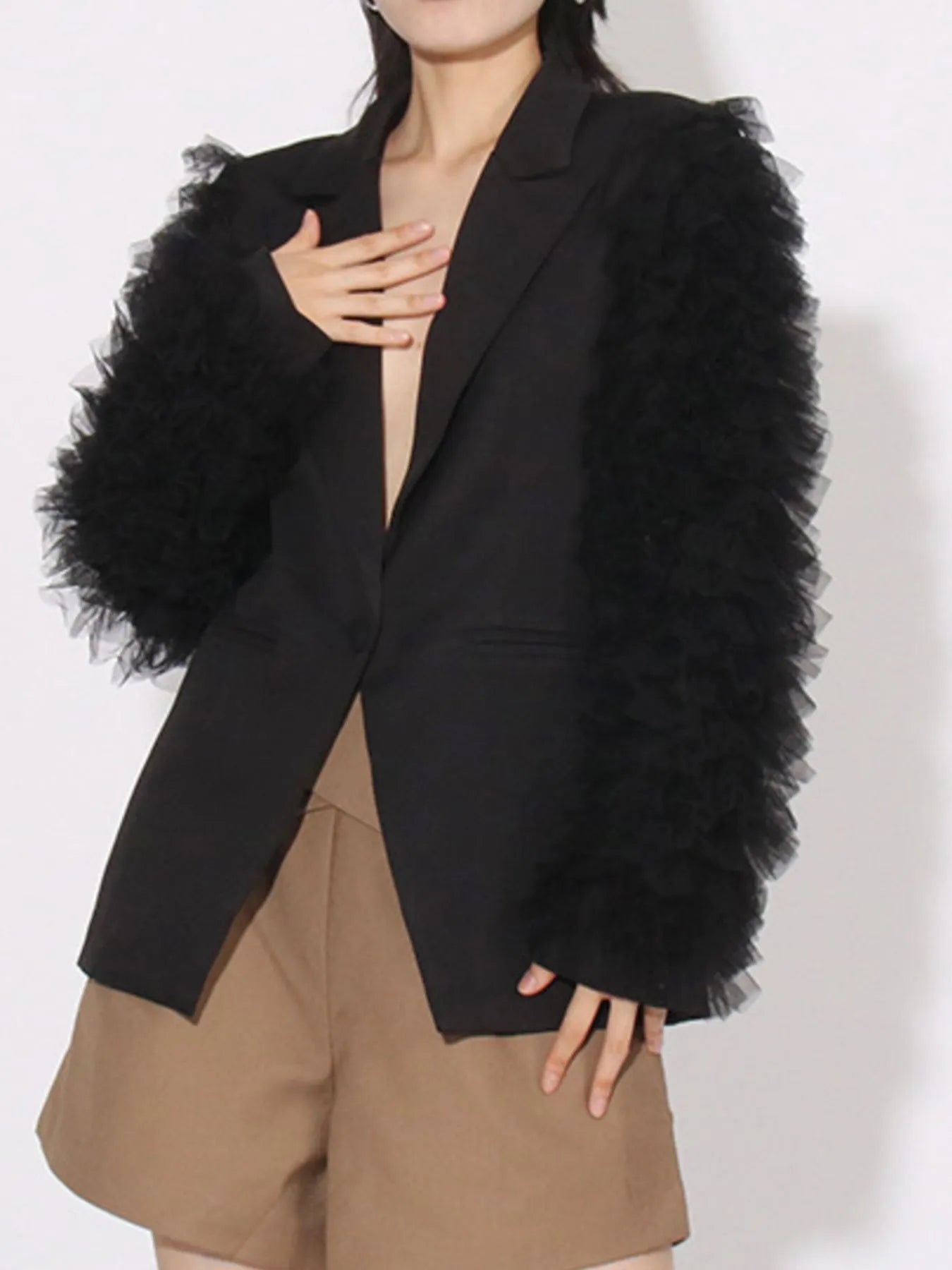 Black blazer with one-button front, open V-neck, and fluffy tulle sleeve detail