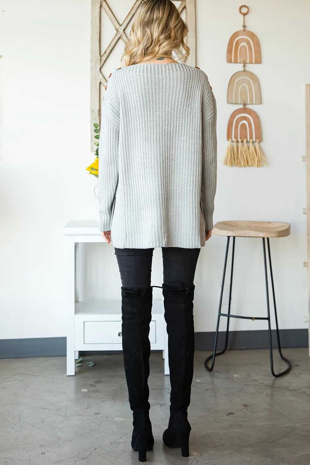 Light gray back view of long-sleeve boat-neck knit sweater with side slits