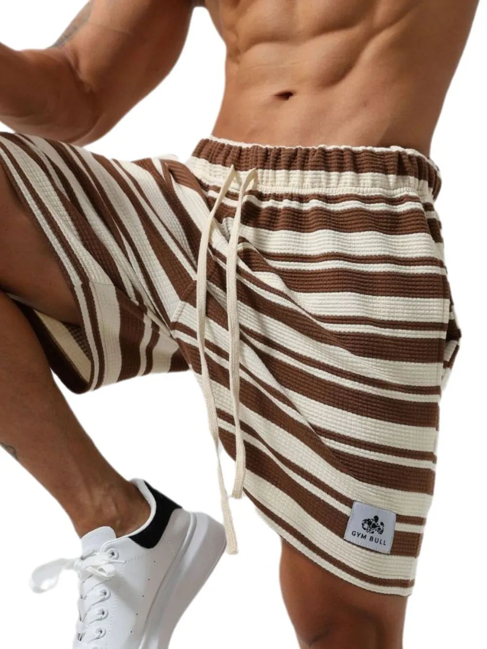 Striped drawstring shorts in brown and white stripes, side view, drawstring and elastic waist