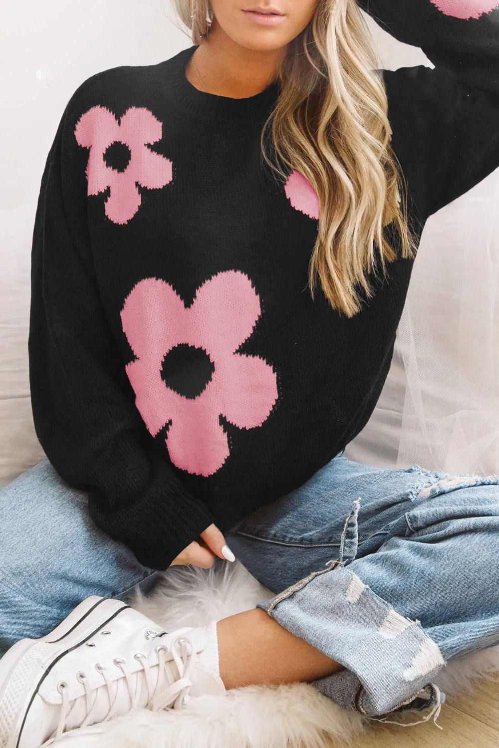 Black long-sleeve sweater with pink floral pattern and round neckline