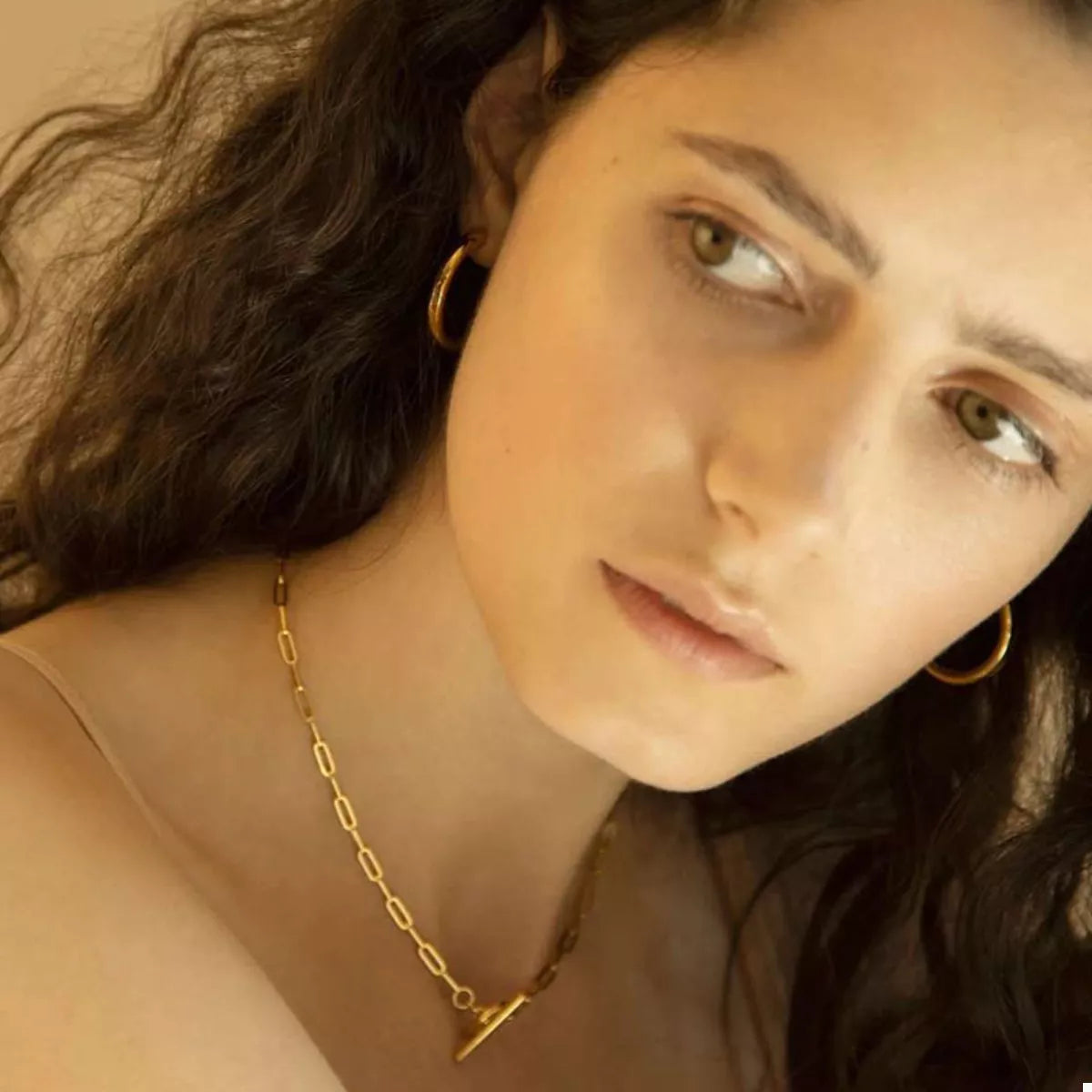 Gold chain link necklace on model