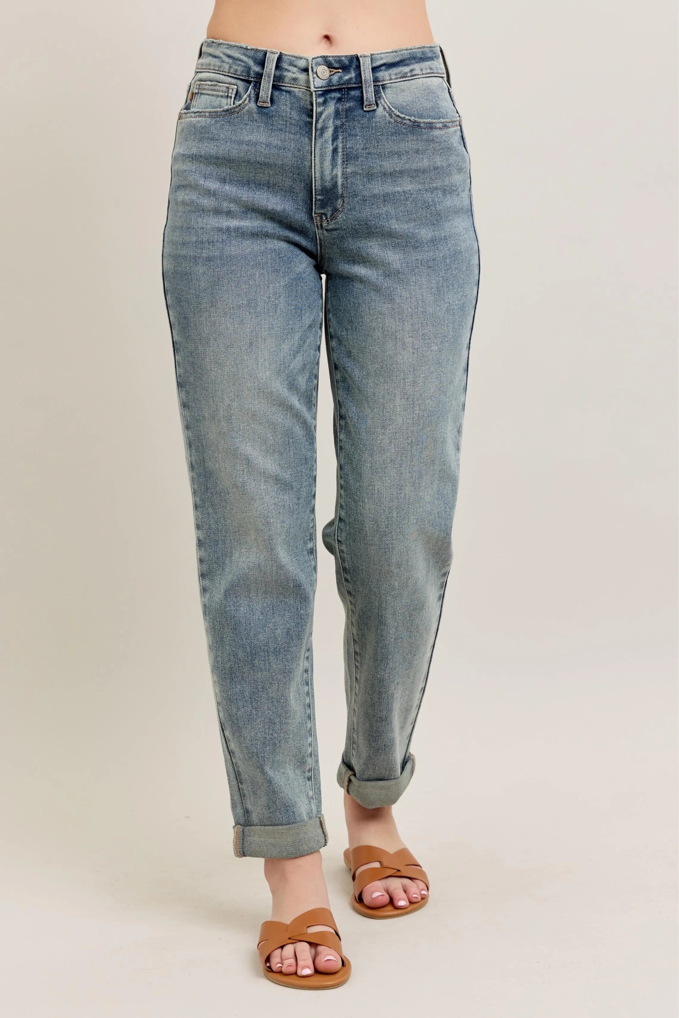 Light blue vintage-wash jeans with double roll cuff on model