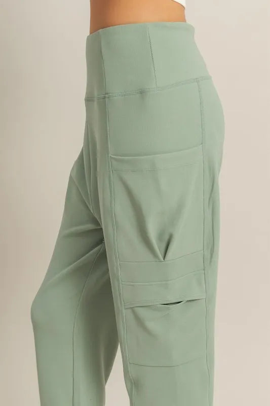 Sage green high-waist sweatpants with back yoke and layered pocket panels