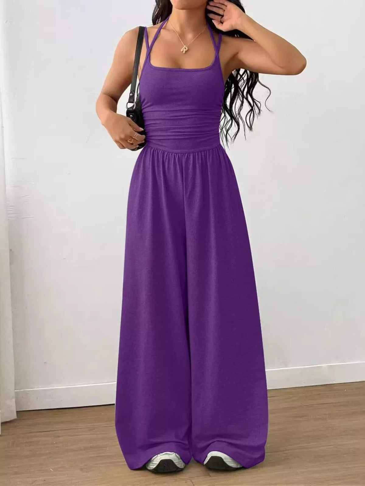 Purple spaghetti strap wide-leg jumpsuit with smocked waist and wide flowing pant legs