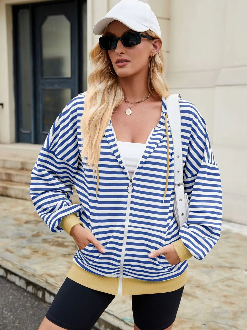 Blue-and-white striped zip-up hoodie with hood and drawstring, long sleeves.