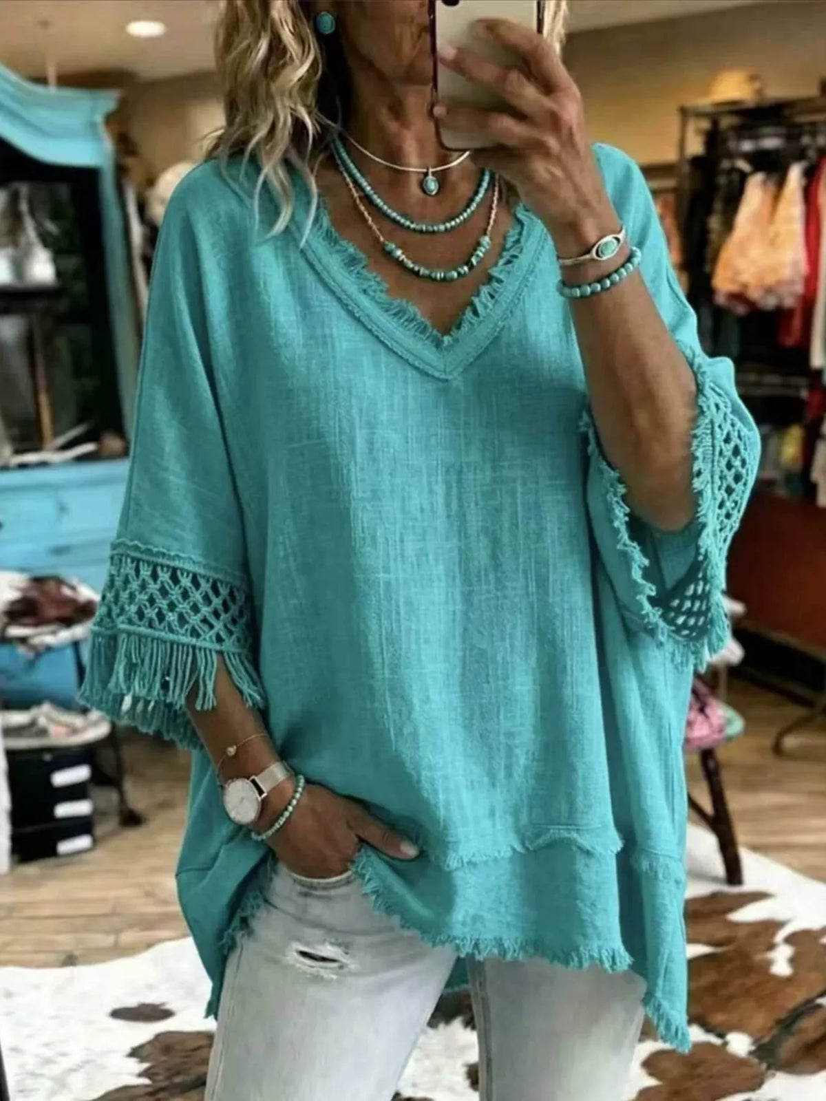 Turquoise loose V-neck blouse with fringe hem and crochet-trim sleeves