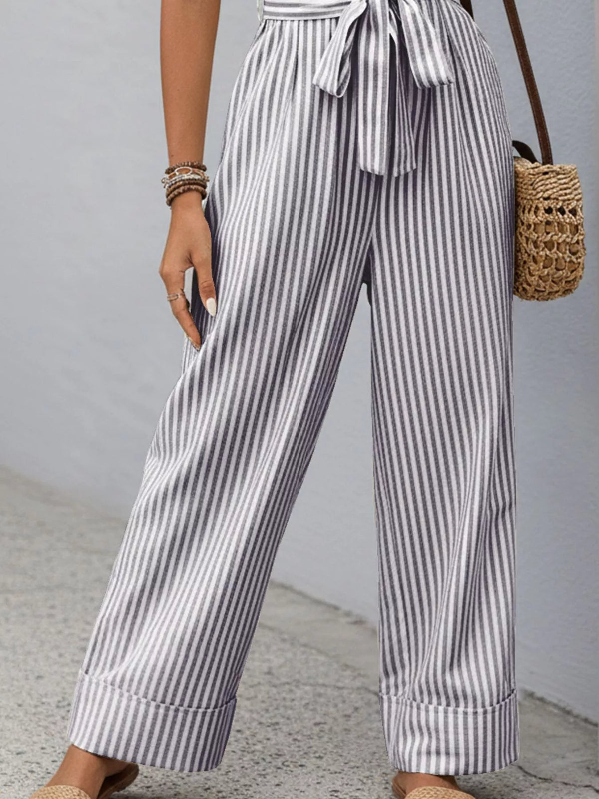 Blue-and-white striped wide-leg sleeveless jumpsuit with V-neck and waist tie