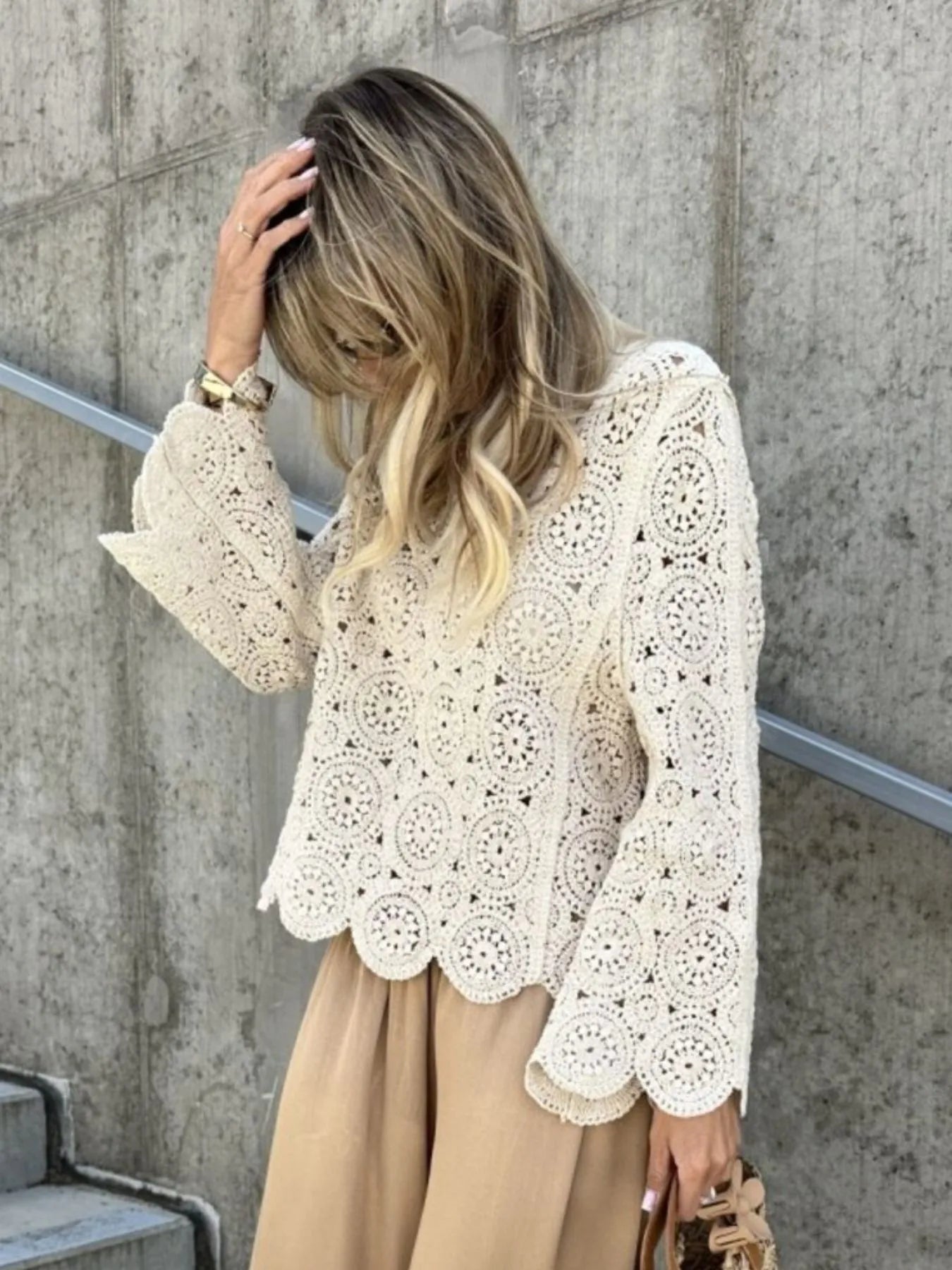 White crochet lace knit top with V-neck, long bell sleeves, and scalloped edge