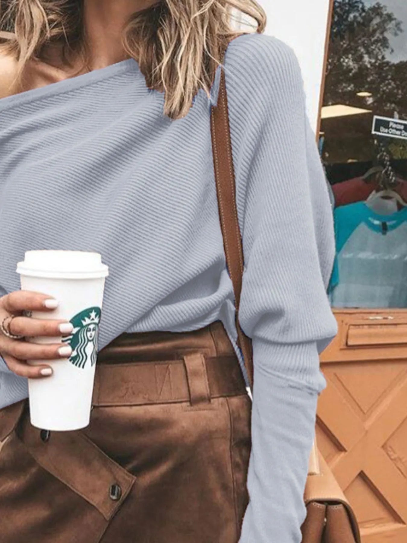 Light blue one-shoulder ribbed sweater, long sleeves and relaxed drape