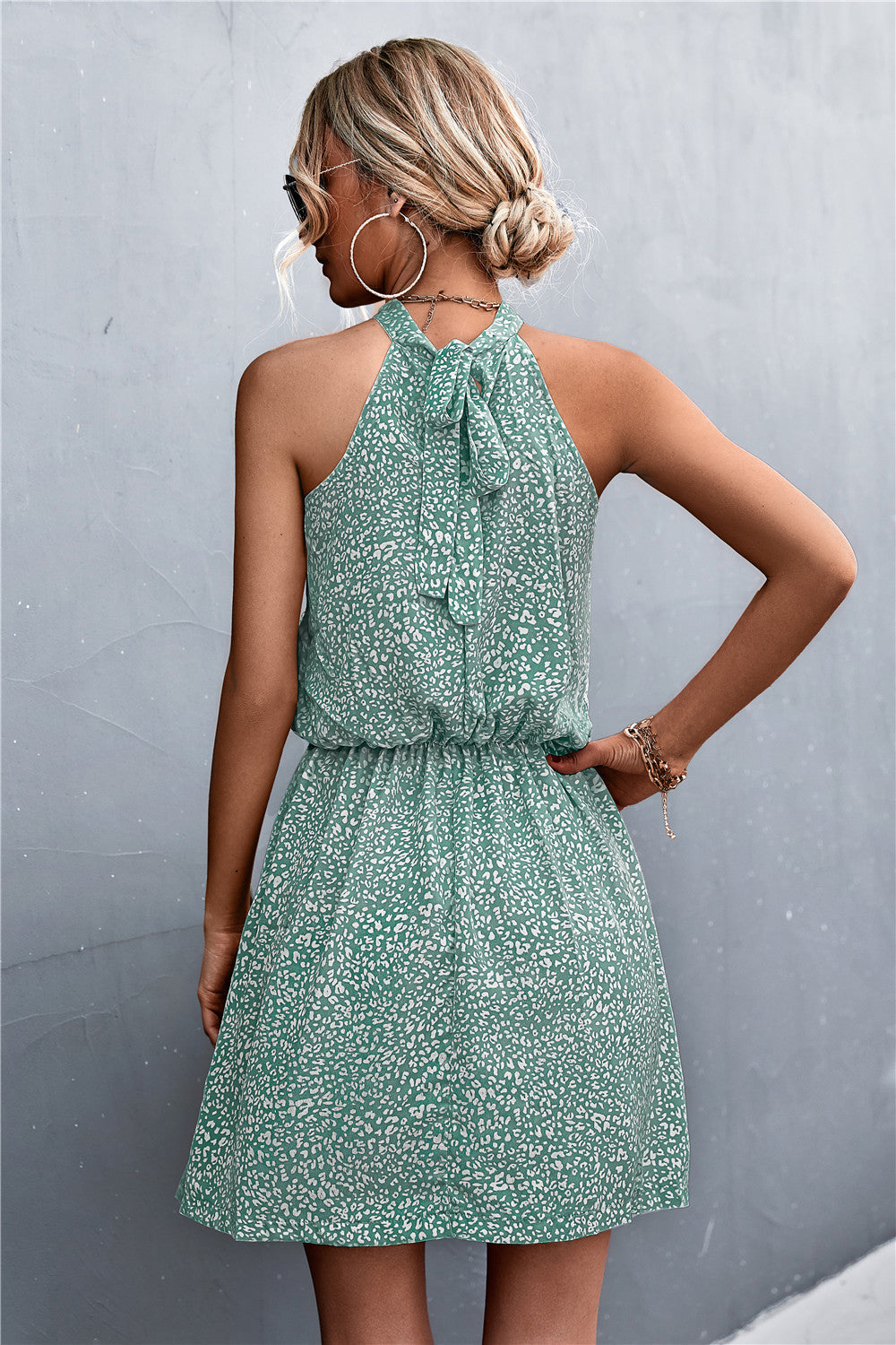 Floral tied sleeveless mini dress in green with high neck tie and gathered waist