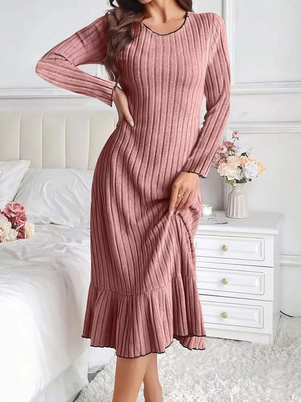 Dusty pink ribbed knit bodycon dress with long sleeves and ruffle hem—front view