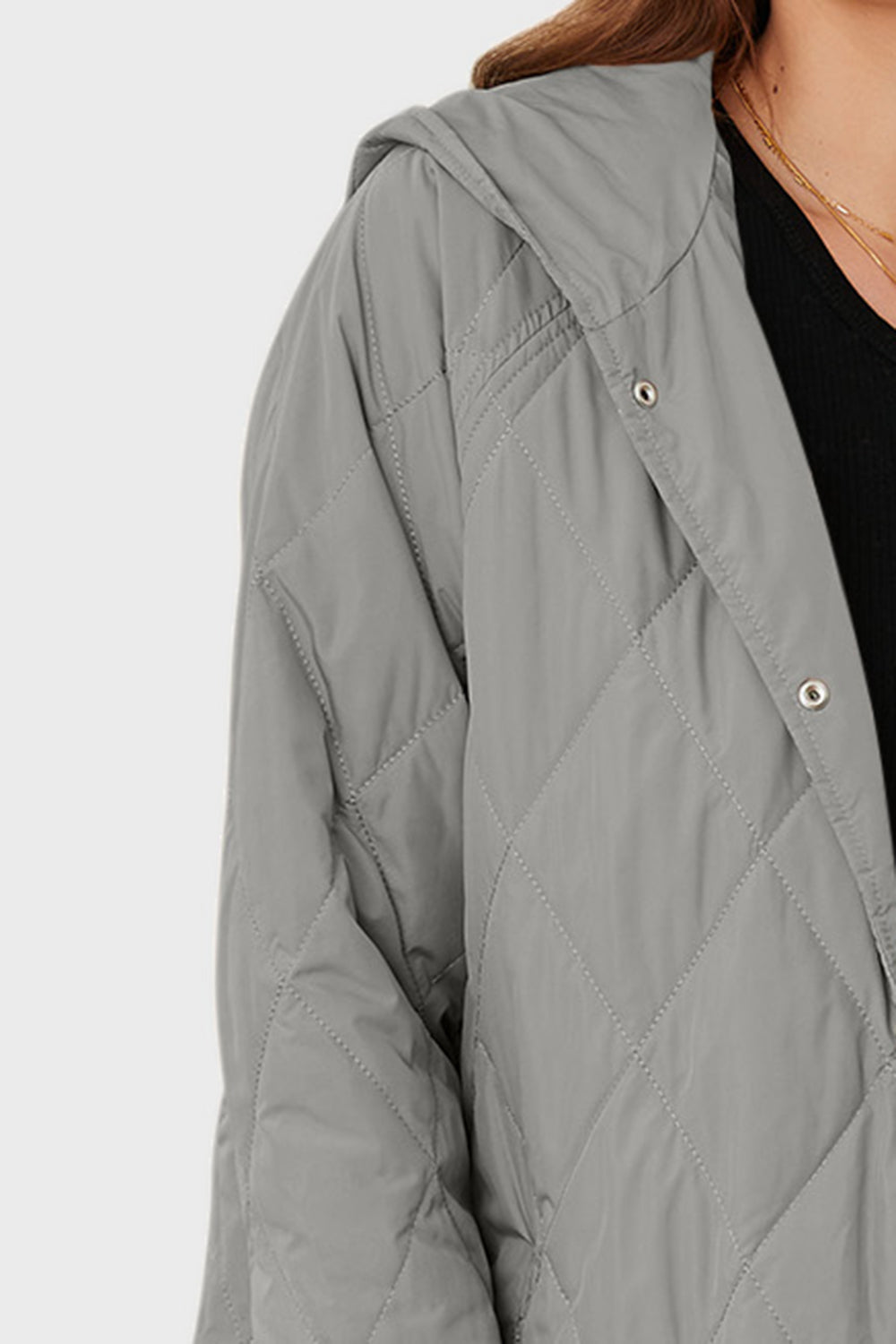 Light gray quilted hooded coat detail with diamond stitching and snap buttons