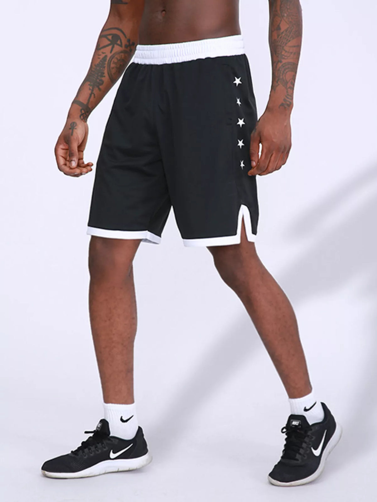 Men's black star-print active shorts with white side stars and contrast trim