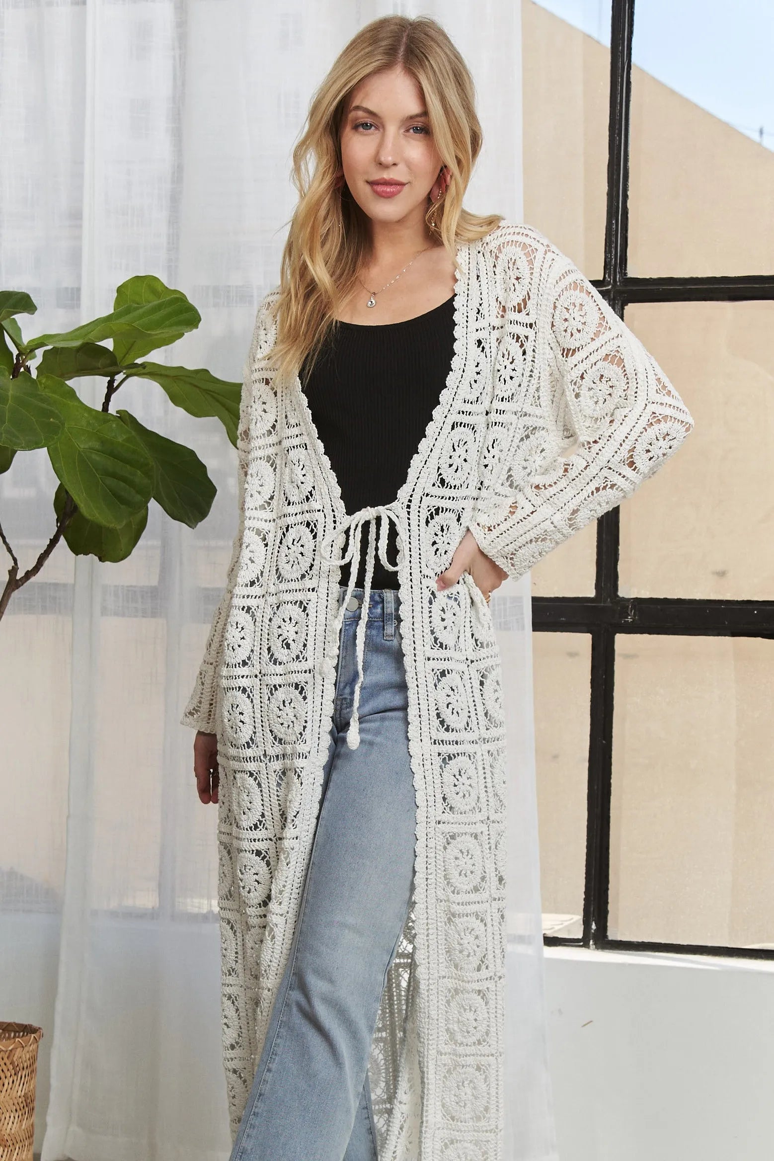 Ivory long crochet cardigan with open front, long sleeves, and repeating medallion squares