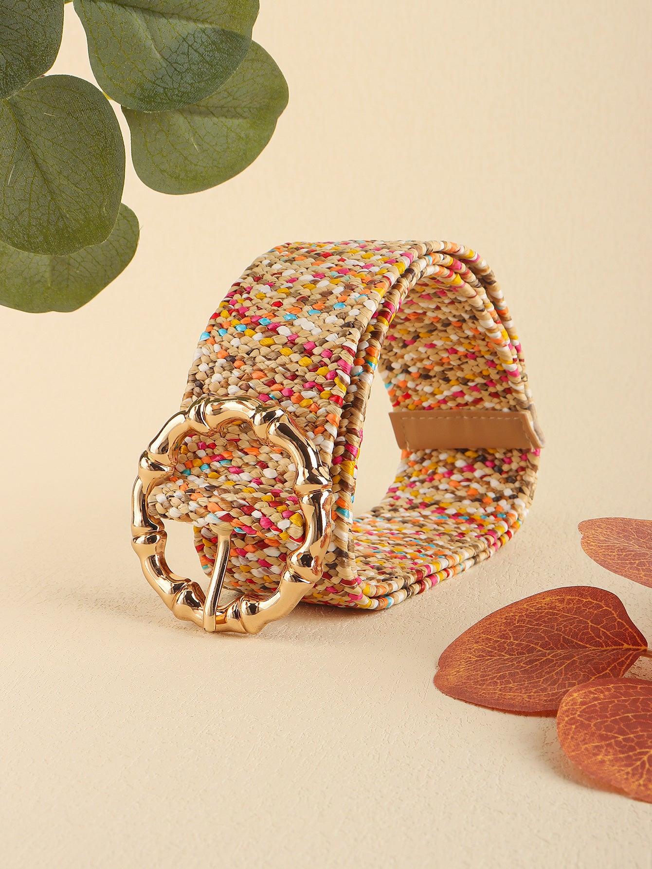Multicolored wide belt, side angle view with gold buckle and tan leather strap ends