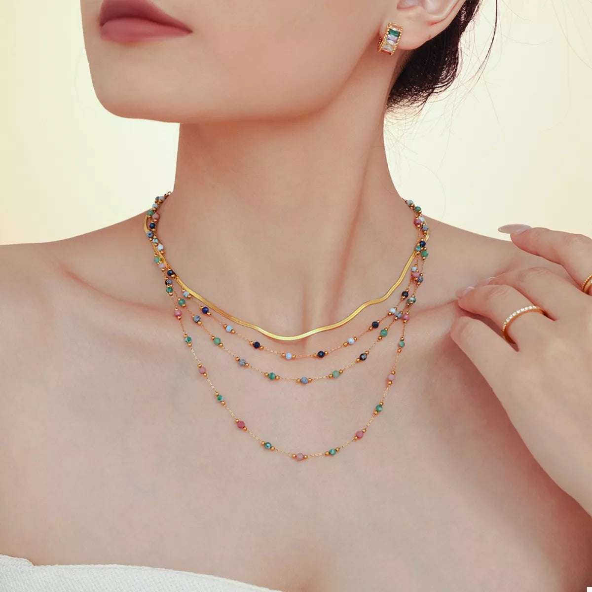 Gold-plated necklace with layered multicolor bead strands and small round spacers