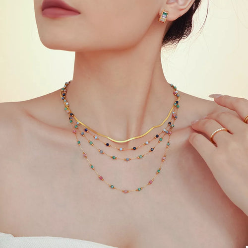 Gold-plated necklace with layered multicolor bead strands and small round spacers