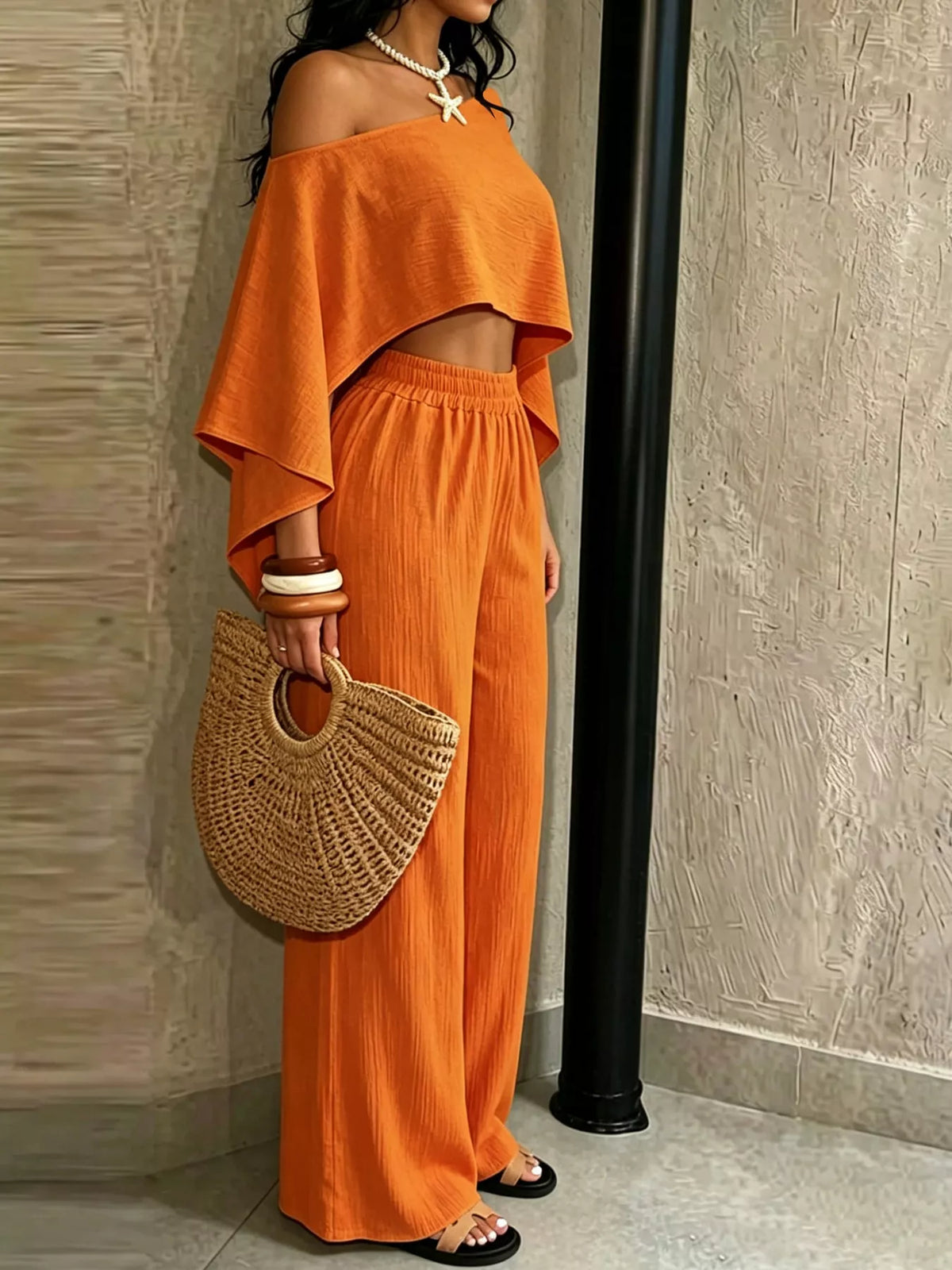 Orange boat-neck crop top and elastic-waist wide-leg pants, front view.
