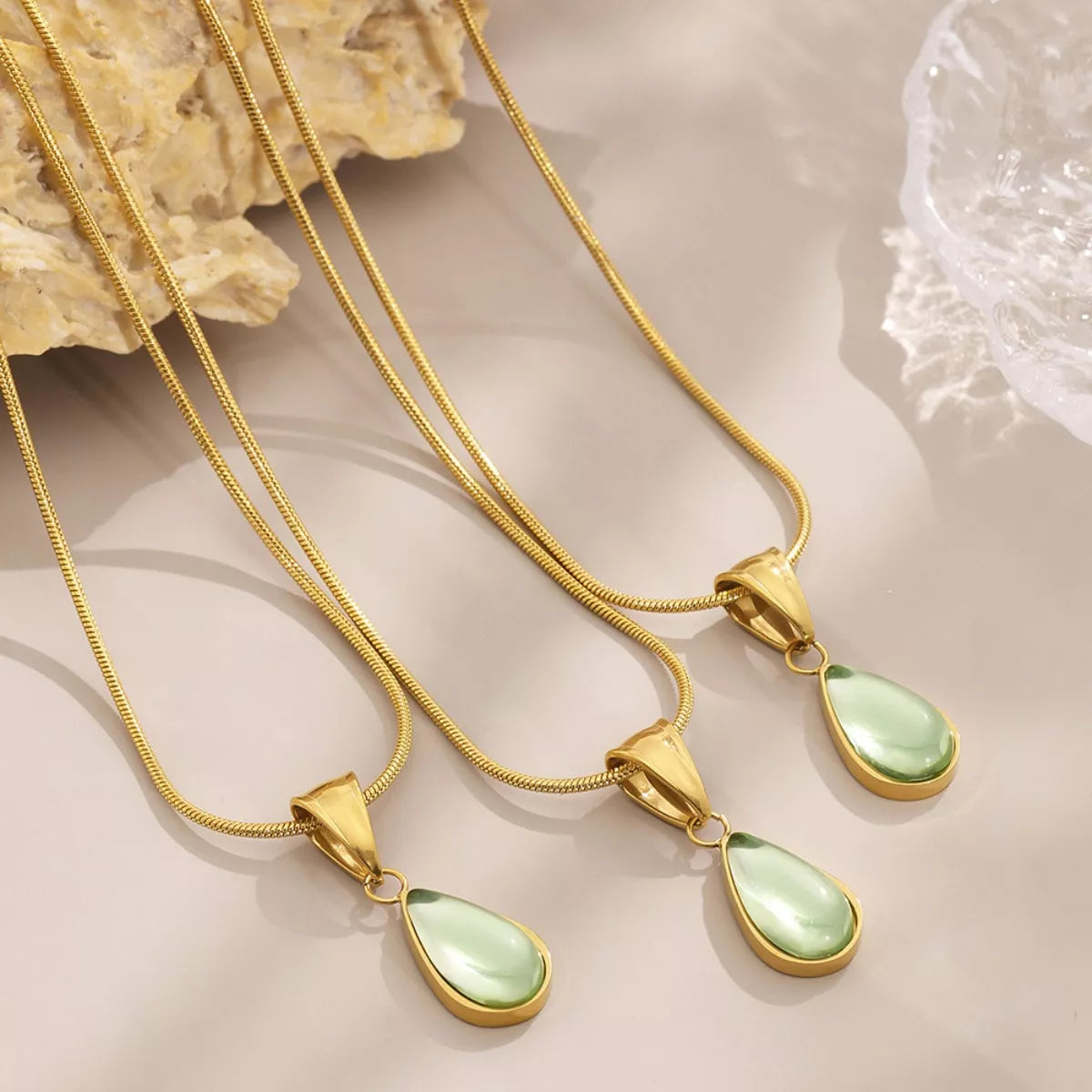 Gold-tone teardrop necklace set with green glass teardrop pendants