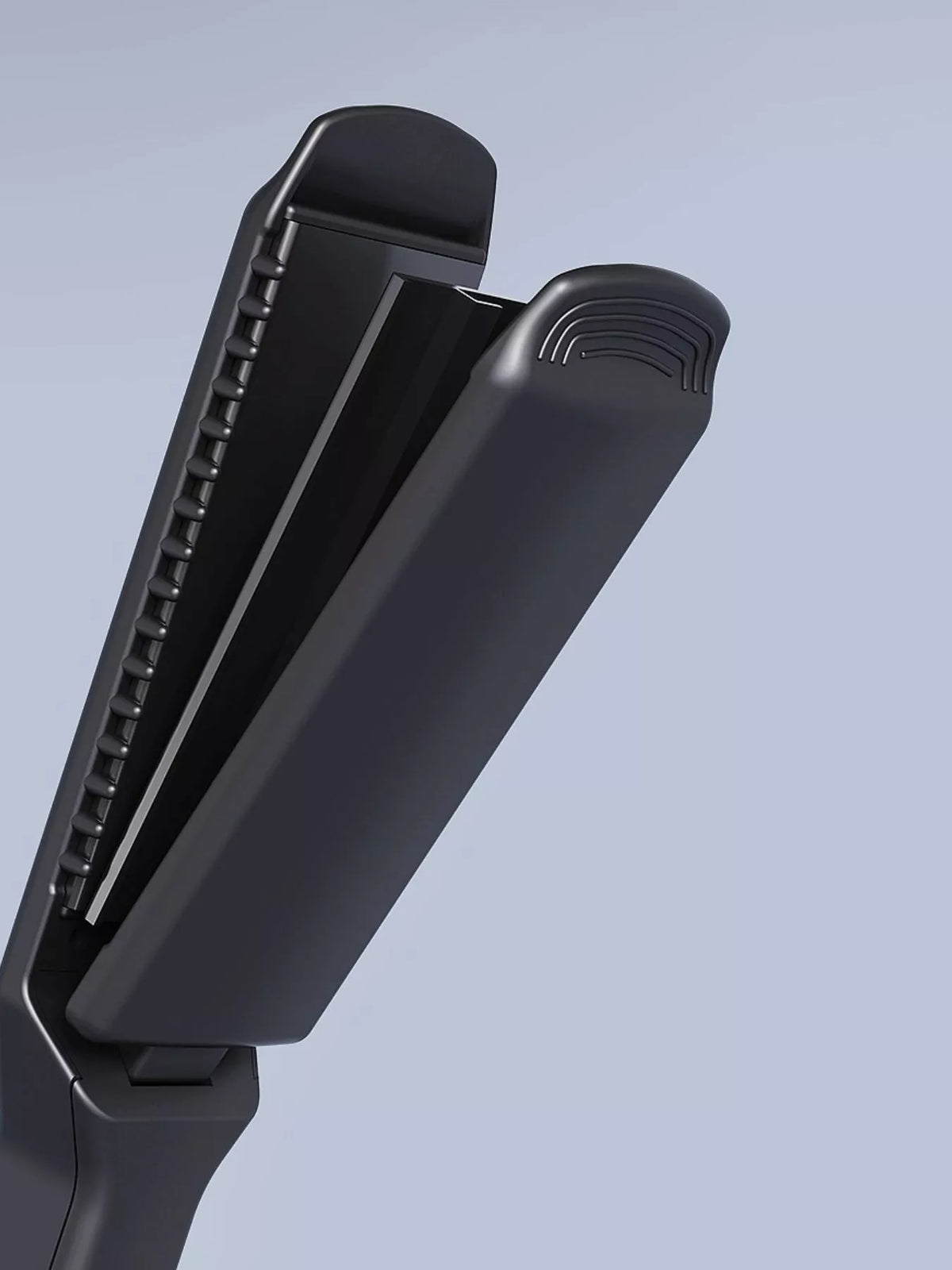 Black hair straightener side view with comb-like vented plates