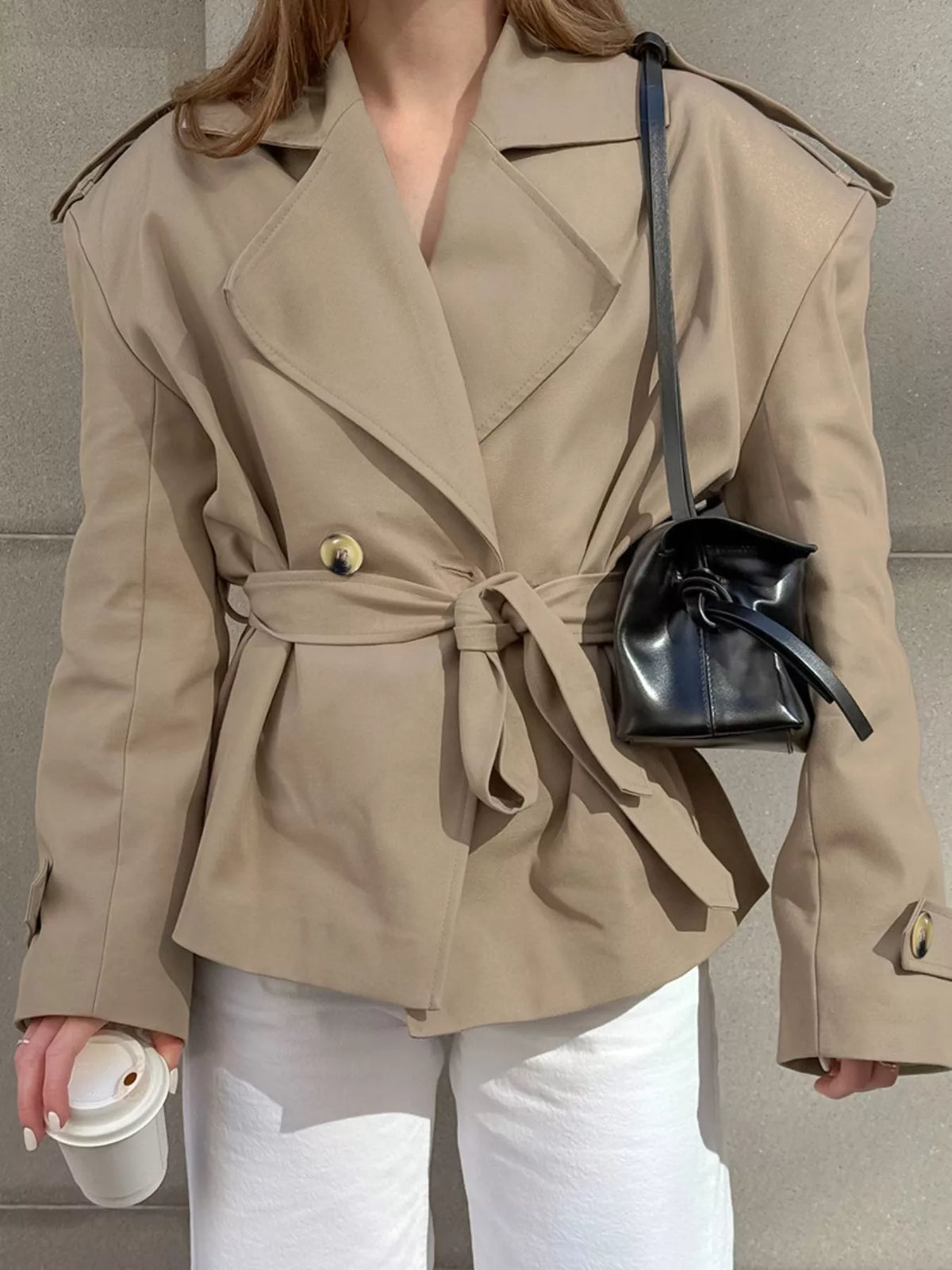 Khaki double-breasted belted trench coat with waist tie and structured shoulder seams