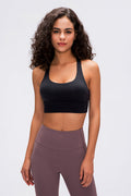 Black sports bra with scoop neckline and wide shoulder straps