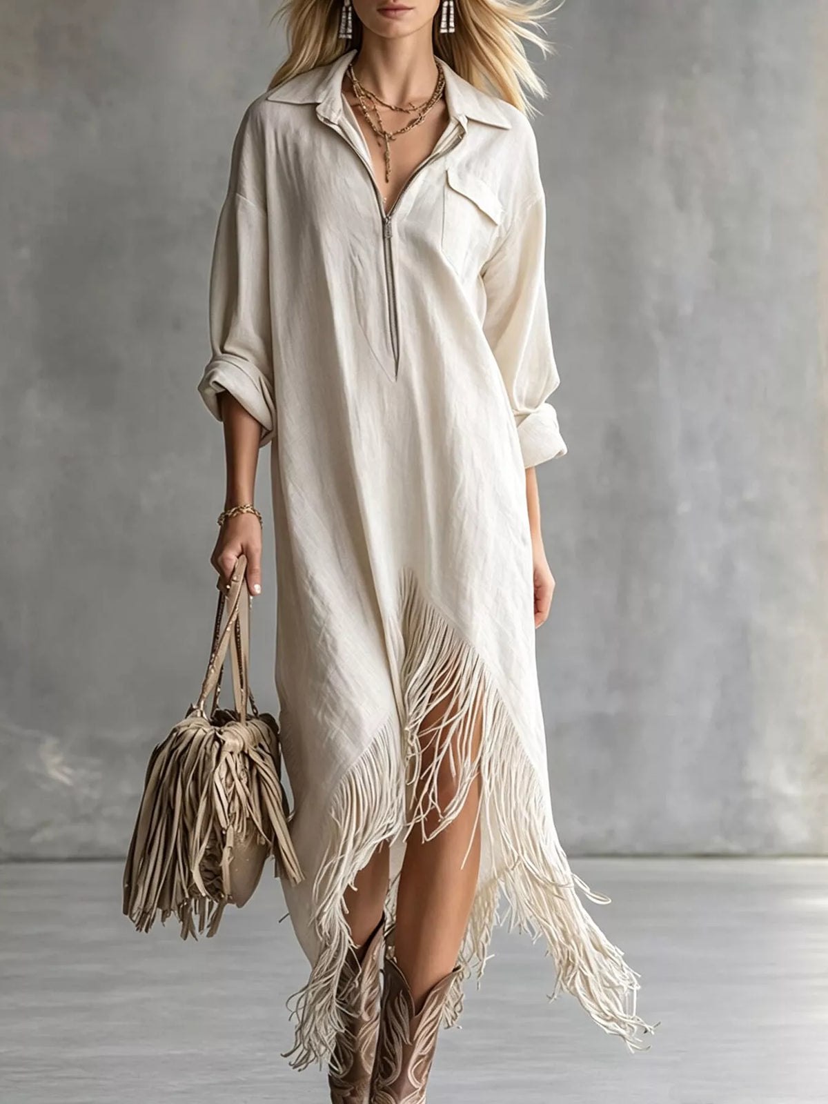 White midi dress with front zipper, pockets, and fringe hem detail