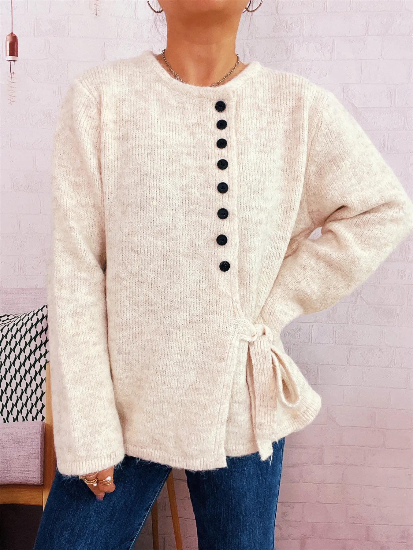 Apricot button-front side-tie sweater, long sleeves, black buttons down the center
