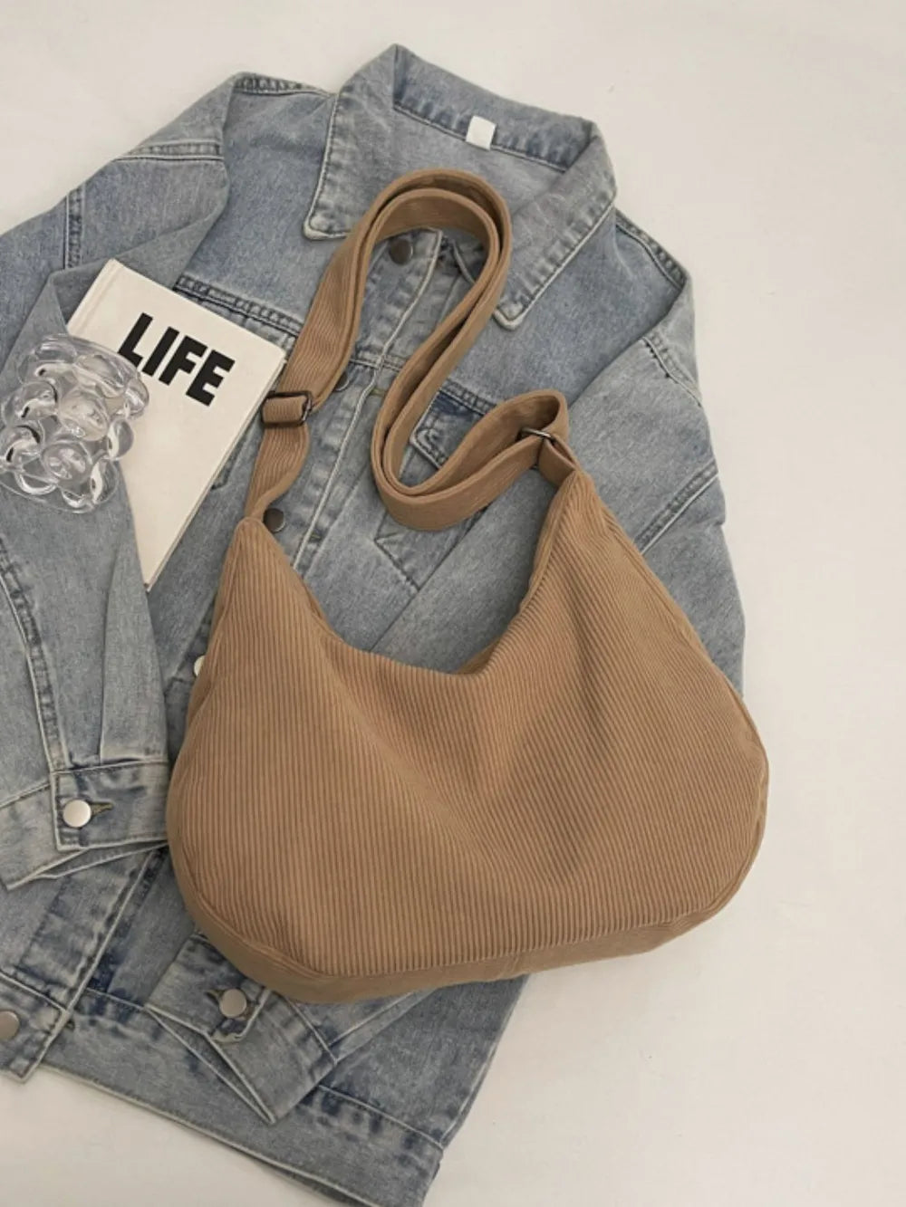Tan ribbed shoulder bag with adjustable strap and drawstring top
