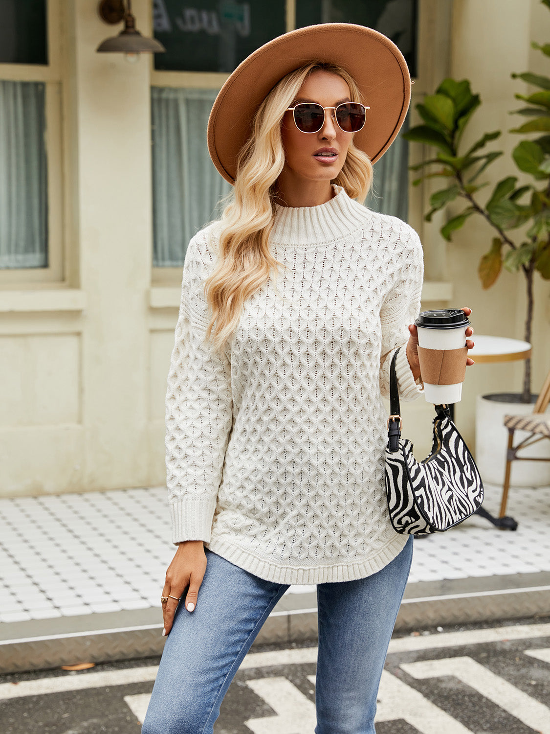 White mock neck knit sweater with textured diamond pattern and long sleeves