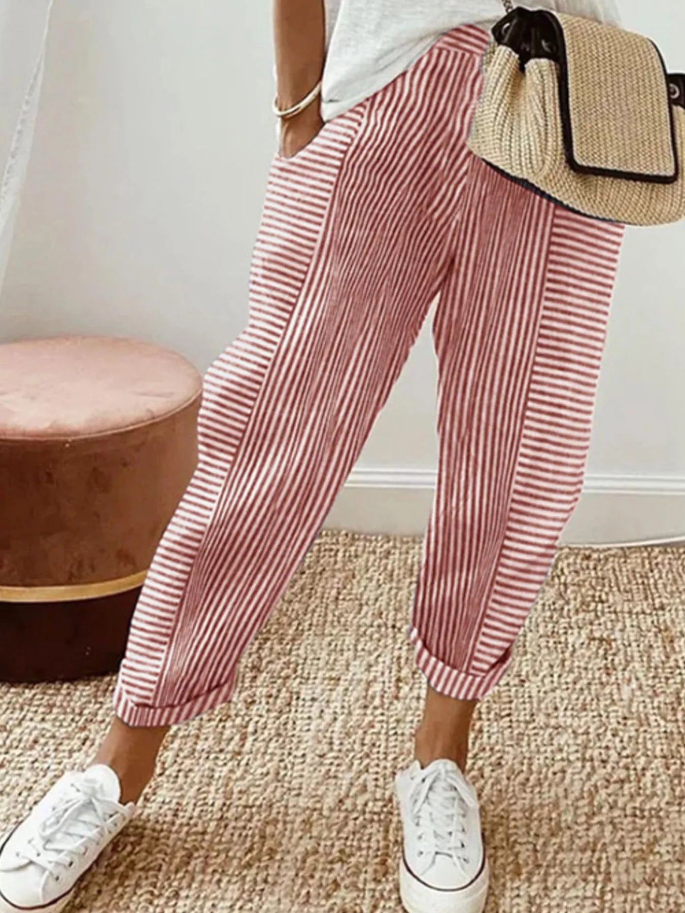 Striped casual pants with pockets, coral and white vertical stripes, ankle cuffs