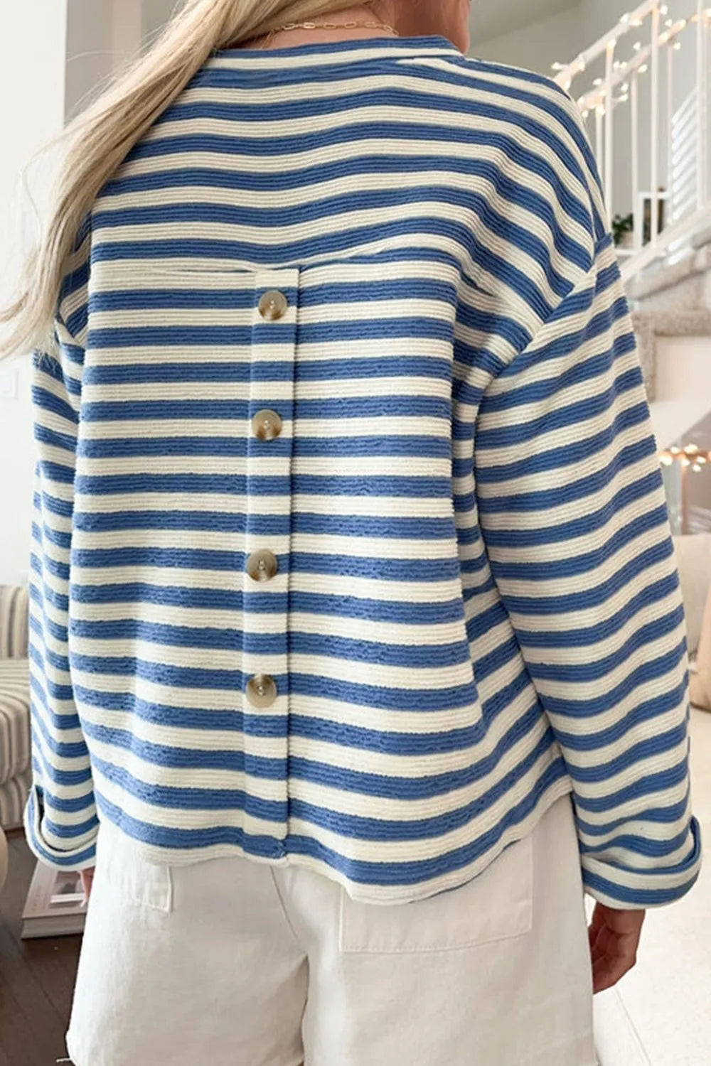 Blue and white striped long-sleeve top with buttoned back placket