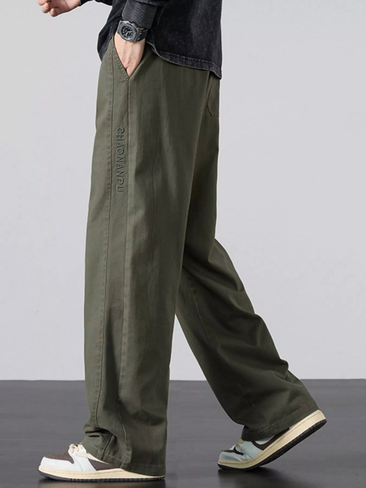Mens army green wide-leg casual pants with elastic waist, drawstring, and cuffed hem
