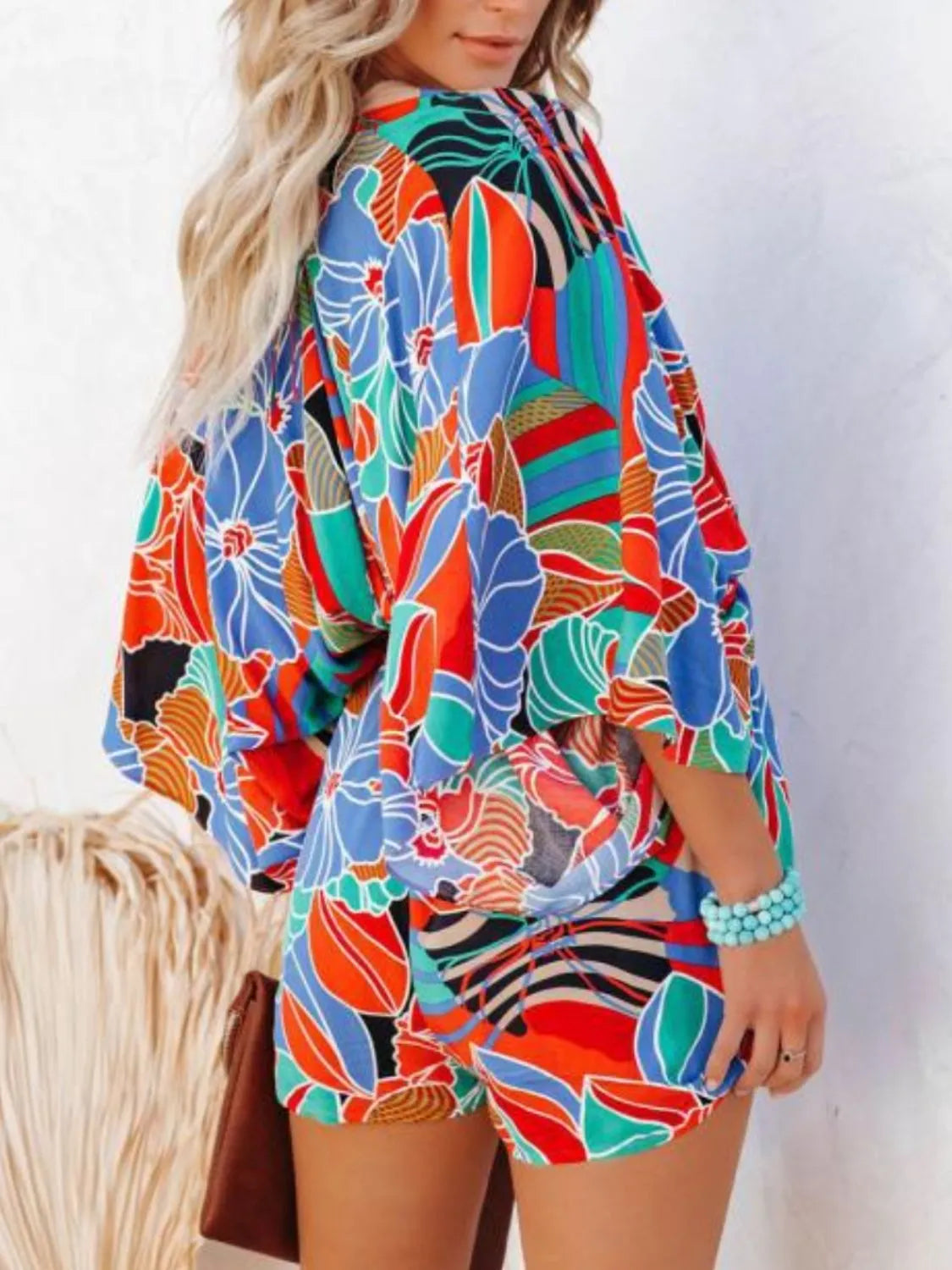 Floral printed romper with V-neck and elastic waist, relaxed shorts and long sleeves